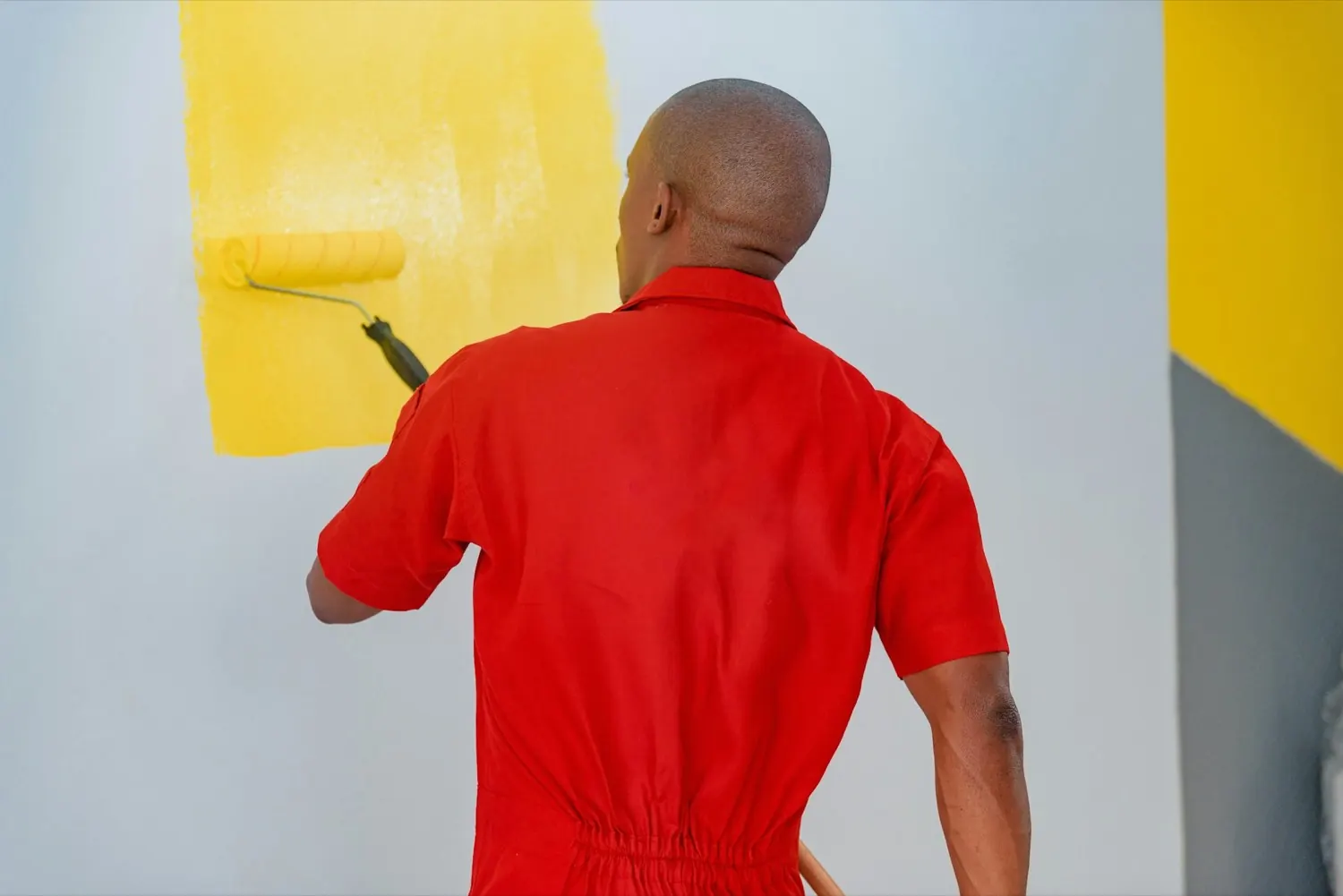 A worker on a job site in bright midday sun