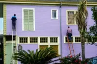 A crew working on a house exterior