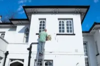 A ladder propped against a house